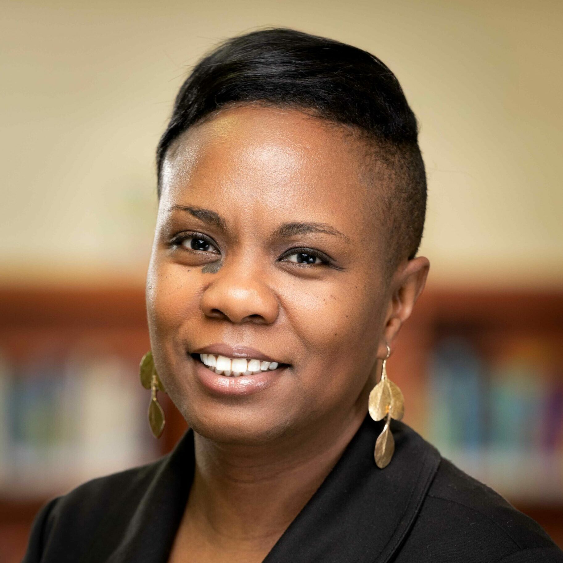Principal Williams-Lawani smiling for a portrait.